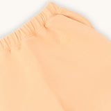 close up of farren logo on apricot kids joggers