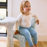 baby on seat with leggings in glacier blue