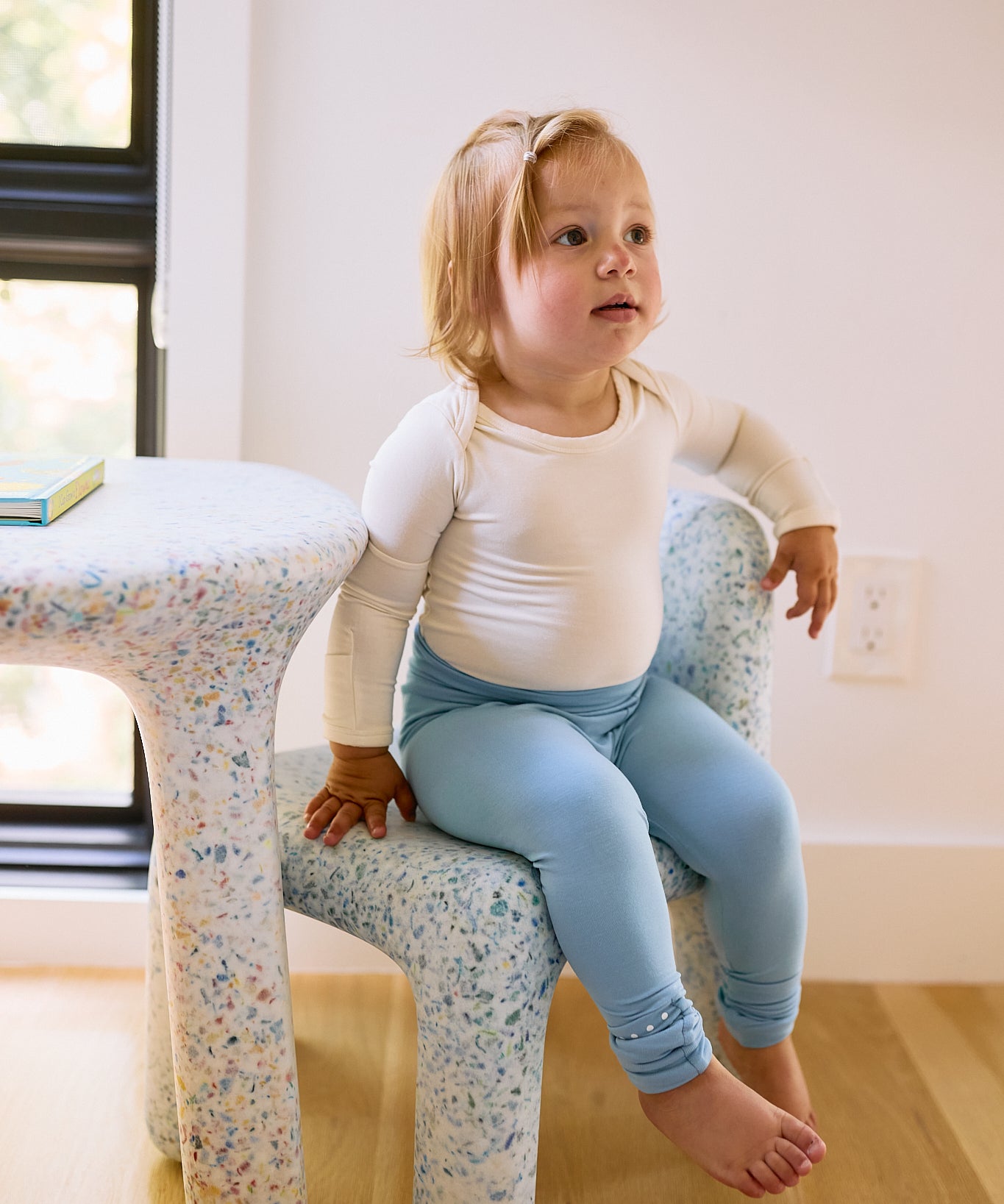 baby on seat with leggings in glacier blue