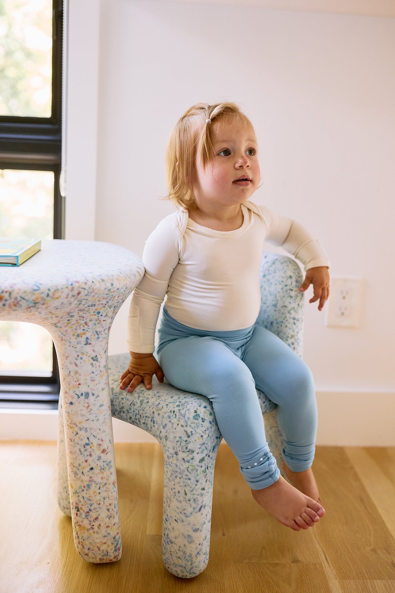 baby on seat with leggings in glacier blue