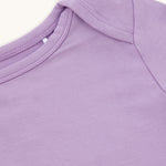 Close-up of the right side of the neck and shoulder of a lilac kid's t-shirt.