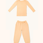 Kids long sleeve t-shirt and joggers set in apricot color.