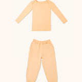 Kids long sleeve t-shirt and joggers set in apricot color.