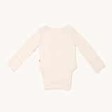 Long sleeve onesie in sand color, viewed from the back