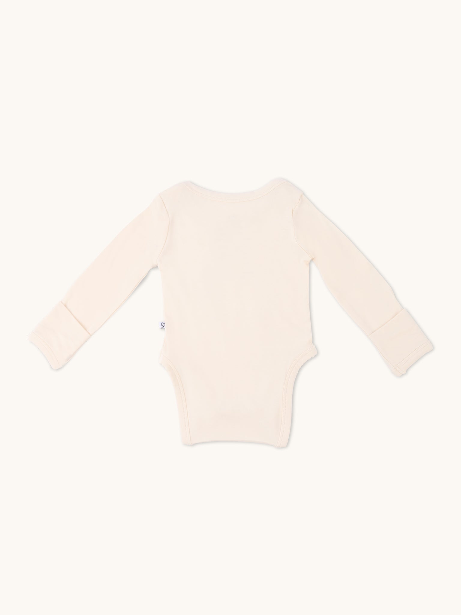 Long sleeve onesie in sand color, viewed from the back