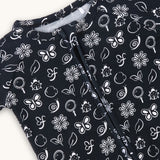 farren nido onseie zipper sleeper black closeup of white details of butterfly flowers and snails