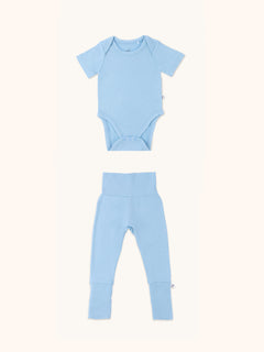 Zoomed-out view of a baby onesie and leggings bundle in glacier blue color.