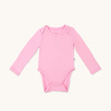 Zoomed-out view of a long sleeve onesie in lotus pink color